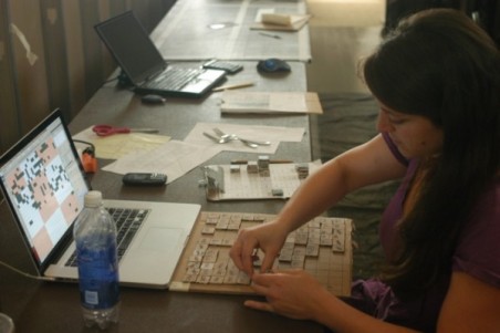Carly Schmitt at work on the One Tile, One Rosemount project. (Photo by Tad Johnson) 
